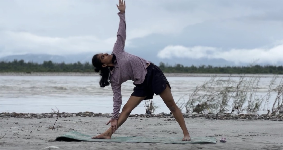 Triangle pose on the riverbank